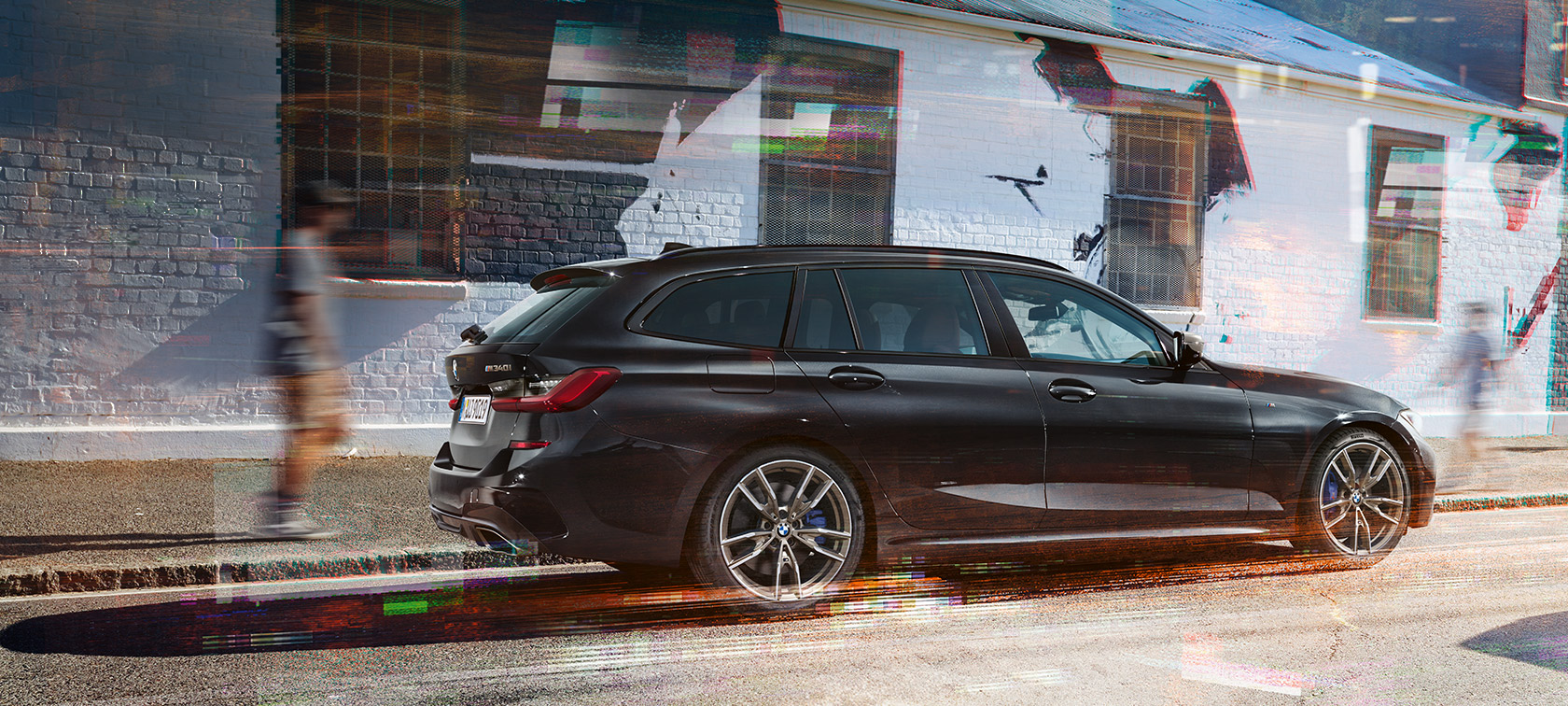 Vue latérale de la BMW M340i xDrive Touring (G21) BMW M340i xDrive Touring (G21) Black Sapphire metallic, vue latérale dans la rue