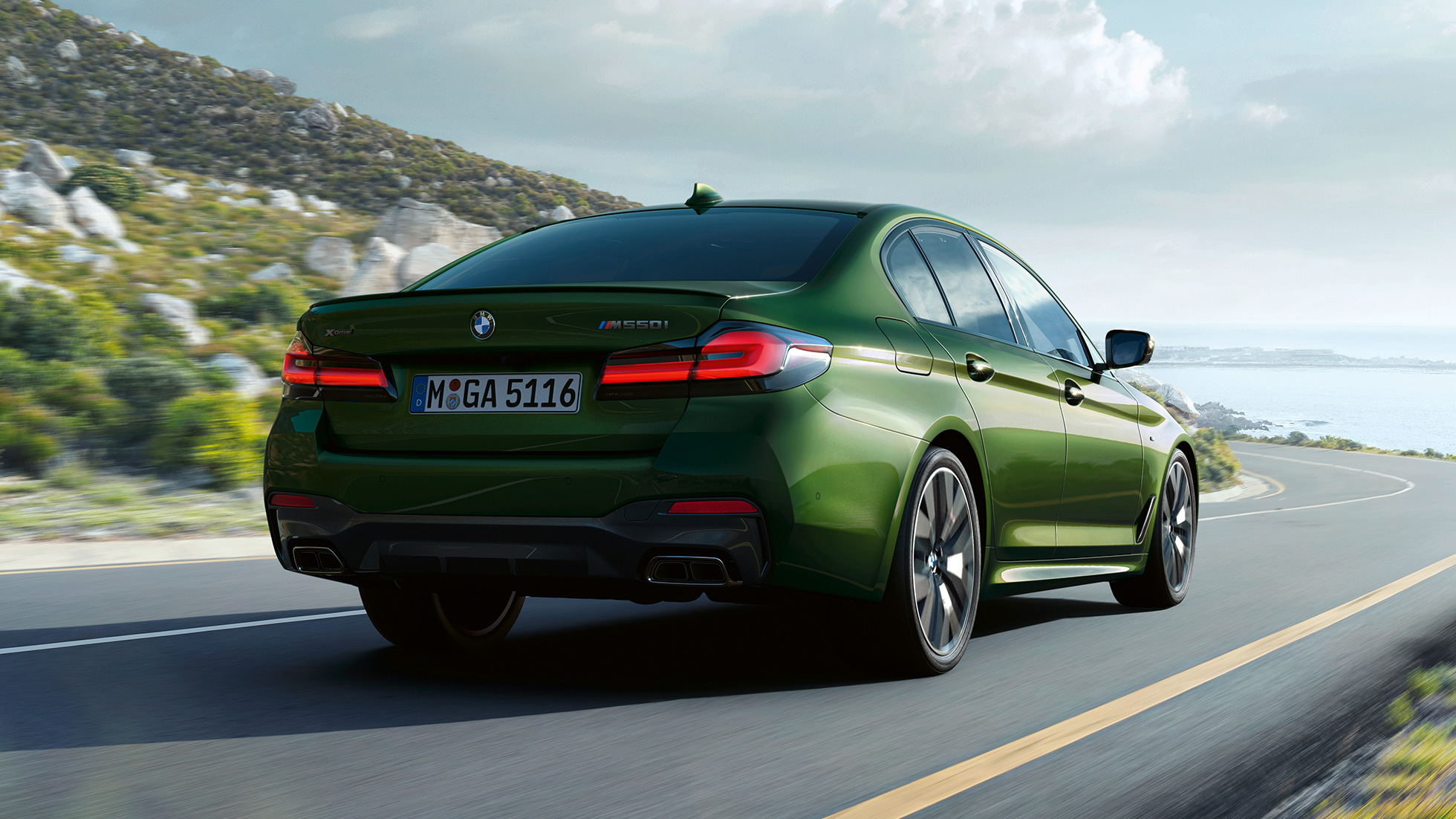 BMW M550i xDrive Limousine G30 LCI Facelift 2020 Heckansicht BMW M550i xDrive Limousine G30 LCI Facelift 2020 BMW Individual Verde Ermes metallic Heckansicht fahrend auf Landstrasse