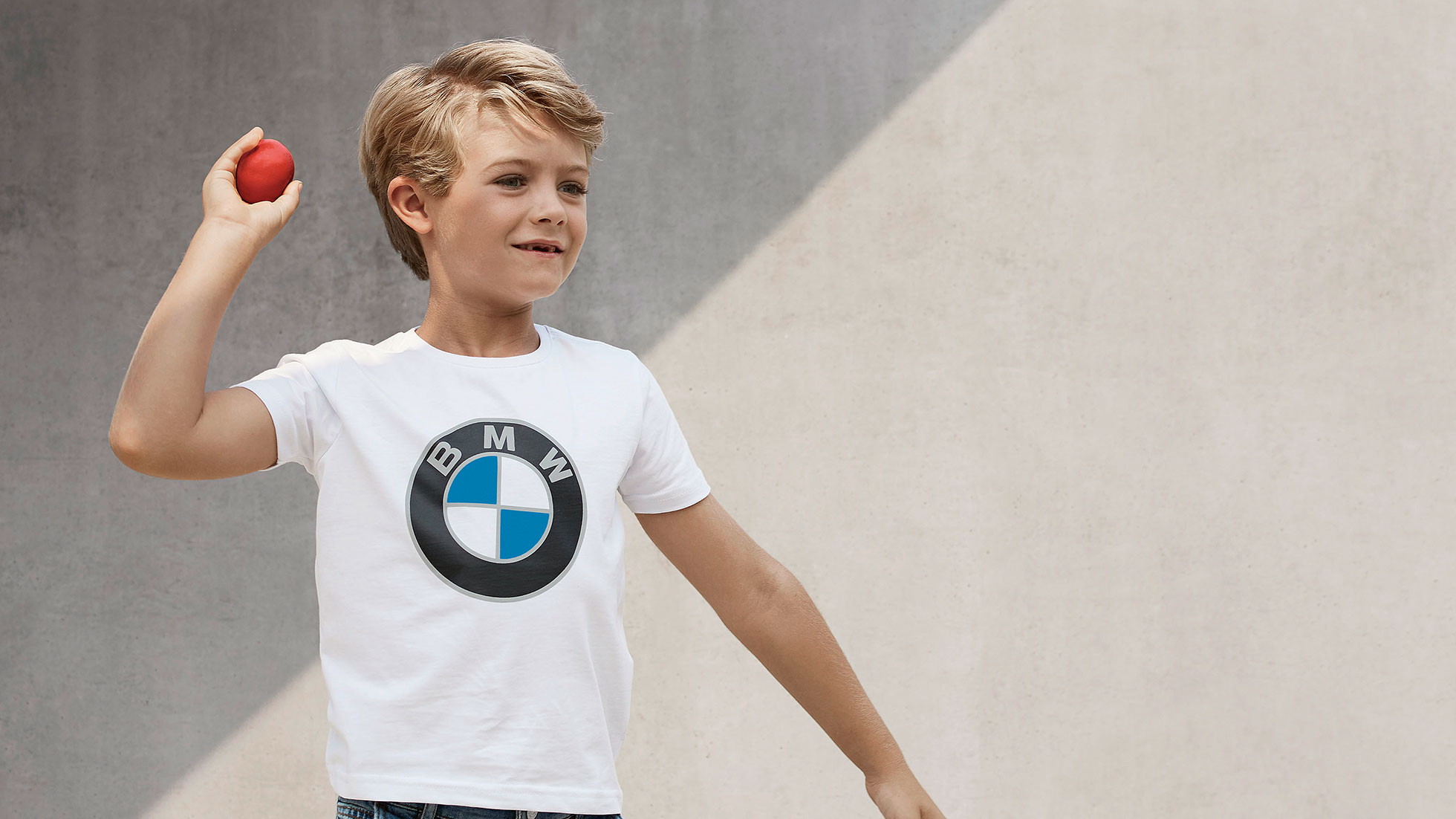 BMW Kids Collection. Un ragazzo indossa capi della BMW Kids Collection.